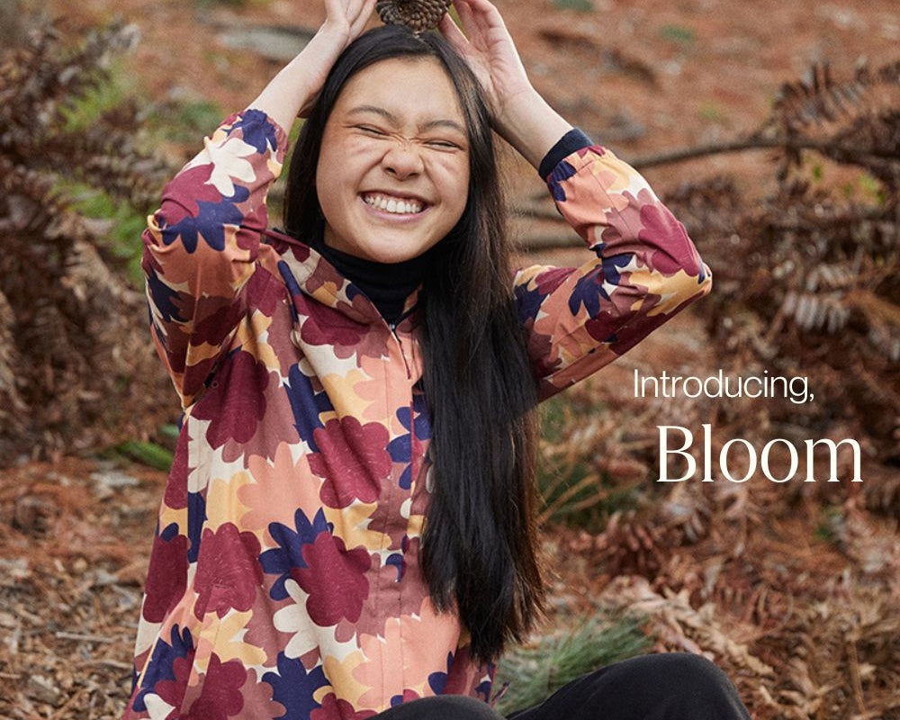 Model smiling wearing the Elements Jacket in Bloom, made by artist Izzy Lawrence